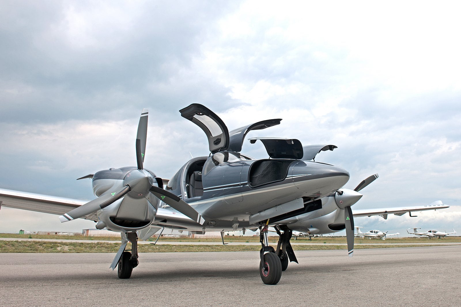 Diamond DA62 on the tarmac with gullwing-style doors open, emphasizing luxury and comfort.